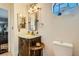 Bathroom boasting rustic vanity with clear countertop, unique mirror, and a small octagon window at 9532 Cliff View Way, Las Vegas, NV 89117