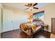 Bedroom featuring wood floors, ceiling fan, window, and minimal decor at 9532 Cliff View Way, Las Vegas, NV 89117