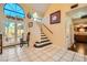 Foyer with stairs to the second level and outdoor access to the pool area at 9532 Cliff View Way, Las Vegas, NV 89117