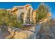 Desert landscaped front yard featuring a fountain, desert plants, stone accents, and inviting curb appeal at 9532 Cliff View Way, Las Vegas, NV 89117