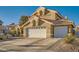 Exterior of a two-story home showing a three car garage, tile roof, and well-maintained desert landscaping at 9532 Cliff View Way, Las Vegas, NV 89117