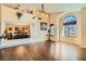 Spacious living room with wood floors, a large arched window, and a view of the dining room at 9532 Cliff View Way, Las Vegas, NV 89117