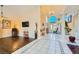 Open-concept living room with hardwood floors, tall columns, and natural light from large arched window at 9532 Cliff View Way, Las Vegas, NV 89117