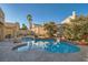 Lush backyard pool with rock accents provides a refreshing retreat, surrounded by privacy walls and landscaping at 9532 Cliff View Way, Las Vegas, NV 89117