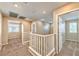 Upstairs hallway features neutral walls, carpeting and white banister with light-filled rooms at 10383 Gwynns Falls St, Las Vegas, NV 89183