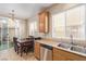 Functional kitchen area that features tile flooring and a double sink at 10433 Amber Night St, Las Vegas, NV 89183