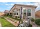 Serene backyard featuring lush artificial turf, a charming stone pathway, and a relaxing swing at 10438 Skye Arroyo Ave, Las Vegas, NV 89166