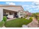 Large backyard with covered patio, artificial turf, a swing and a barbecue, ideal for entertaining at 10438 Skye Arroyo Ave, Las Vegas, NV 89166