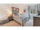 Comfortable bedroom features a queen-size bed, neutral color palette, and bright natural light at 10438 Skye Arroyo Ave, Las Vegas, NV 89166