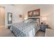 Comfortable bedroom featuring a queen-size bed, neutral color palette, and bright natural light at 10438 Skye Arroyo Ave, Las Vegas, NV 89166