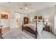 Well-lit bedroom with a ceiling fan, plush carpet, and stylish furnishings at 10438 Skye Arroyo Ave, Las Vegas, NV 89166