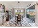 Bright dining room with chandelier, decorative rug, and sliding door to backyard at 10438 Skye Arroyo Ave, Las Vegas, NV 89166