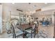 Open-concept dining area with backyard access, chandelier, and decorative rug at 10438 Skye Arroyo Ave, Las Vegas, NV 89166