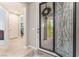 Inviting entryway features decorative glass door and sidelight with views into the home's open layout at 10438 Skye Arroyo Ave, Las Vegas, NV 89166