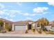 Charming single-story home with stone accents, a tile roof, and a well-manicured front yard at 10438 Skye Arroyo Ave, Las Vegas, NV 89166