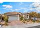Charming single-story home with a two-car garage, stone accents, and a beautifully landscaped front yard at 10438 Skye Arroyo Ave, Las Vegas, NV 89166