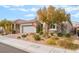 Attractive single-Gathering home with a two-car garage, a well-maintained yard, and appealing stone detailing at 10438 Skye Arroyo Ave, Las Vegas, NV 89166