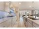 Chef's kitchen featuring sleek countertops, custom cabinetry, and a seamless flow to the dining area at 10438 Skye Arroyo Ave, Las Vegas, NV 89166