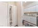 Bright laundry room featuring ample storage cabinets and granite countertops at 10438 Skye Arroyo Ave, Las Vegas, NV 89166