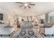 Open-concept living area with stylish furnishings, seamless flow to kitchen, and modern decor accents at 10438 Skye Arroyo Ave, Las Vegas, NV 89166
