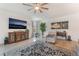 Spacious living area with wood-look floors, entertainment center, and comfortable seating arrangement at 10438 Skye Arroyo Ave, Las Vegas, NV 89166