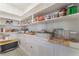 Organized walk-in pantry with white shelving and ample storage space at 10438 Skye Arroyo Ave, Las Vegas, NV 89166