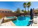 Enjoy a backyard oasis with a refreshing pool, relaxing spa, and swaying palm trees for the ultimate tranquil retreat at 1138 Grove Park St, Henderson, NV 89002