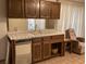 Home wet bar with mirrored backsplash, tile countertops, and built-in cabinets at 1212 Santa Ynez Ave, Henderson, NV 89002