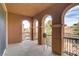 Inviting covered balcony featuring arched columns, decorative railing, and scenic views of the neighborhood at 1272 Olivia Pkwy, Henderson, NV 89011