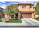 Charming two-story home featuring a well-manicured front yard and inviting entrance with decorative brick pillars at 1272 Olivia Pkwy, Henderson, NV 89011