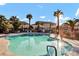 Inviting community pool featuring clear water and a well-maintained apartment complex with palm trees at 1316 Driscoll Dr # 102, Las Vegas, NV 89128