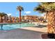 Community pool features lounge chairs, palm trees, and a well-maintained apartment complex on a sunny day at 1316 Driscoll Dr # 102, Las Vegas, NV 89128