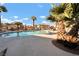 Bright community pool view, showing lounge area with palm trees and well-maintained apartment complex at 1316 Driscoll Dr # 102, Las Vegas, NV 89128