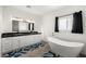 Bright bathroom featuring a soaking tub, double sink vanity, and modern fixtures at 1601 W Calvada Blvd, Pahrump, NV 89048