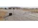 View of a residential home with minimalist front yard and chain-link fence in a desert community at 1601 W Calvada Blvd, Pahrump, NV 89048