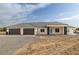 Beautiful single-story home boasts a spacious three-car garage, modern design, and drought-resistant landscaping at 1601 W Calvada Blvd, Pahrump, NV 89048