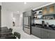 Kitchen area featuring gray cabinets, stainless steel appliances, and decorative shelving at 1601 W Calvada Blvd, Pahrump, NV 89048