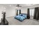 Bright bedroom featuring a comfortable bed, ceiling fan, and neutral decor at 1601 W Calvada Blvd, Pahrump, NV 89048