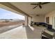 Covered patio area for entertaining with a ceiling fan and lounge furniture at 1601 W Calvada Blvd, Pahrump, NV 89048