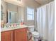 Bathroom featuring a single sink vanity, a toilet, and a shower with curtain at 172 Turtle Ridge Ave, Las Vegas, NV 89183