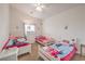 Bedroom includes three beds, neutral walls, a ceiling fan, and a window at 172 Turtle Ridge Ave, Las Vegas, NV 89183