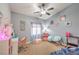 Bedroom with gray walls, neutral carpet, and a ceiling fan at 172 Turtle Ridge Ave, Las Vegas, NV 89183