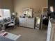 Neutral bedroom with an antique white dresser, desk, and plenty of natural light from the large windows at 172 Turtle Ridge Ave, Las Vegas, NV 89183