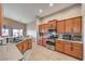 Well-lit kitchen with granite counters, and stainless steel appliances with views of the dining and living area at 172 Turtle Ridge Ave, Las Vegas, NV 89183