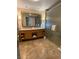 Bathroom featuring a double vanity, a large framed mirror, and glass enclosed shower at 2000 N Fashion Show Dr # 1728, Las Vegas, NV 89109
