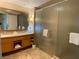 Elegant bathroom featuring a double vanity, a large framed mirror, and glass enclosed shower at 2000 N Fashion Show Dr # 1728, Las Vegas, NV 89109