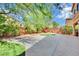 This backyard boasts a patterned concrete patio, string lights, desert landscaping, and ample space for outdoor enjoyment at 2212 Barton Mill Ct, North Las Vegas, NV 89084