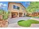 Expansive backyard features a spacious patio, a pergola, lush landscaping, and mature trees, perfect for outdoor entertaining at 2212 Barton Mill Ct, North Las Vegas, NV 89084