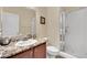 Modern bathroom featuring a granite countertop vanity and glass enclosed shower at 2212 Barton Mill Ct, North Las Vegas, NV 89084