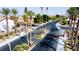 Gated community entrance with palm trees and well-maintained landscaping creating an inviting and secure environment at 2212 Barton Mill Ct, North Las Vegas, NV 89084